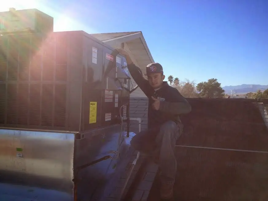 HVAC technician performing AC Tune-Up on a rooftop unit in Broadview Park